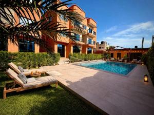 a swimming pool in front of a building at Teranga Tides in Bijilo