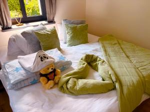 a teddy bear sitting on top of a bed at Apartmány CHATTA in Horní Maršov