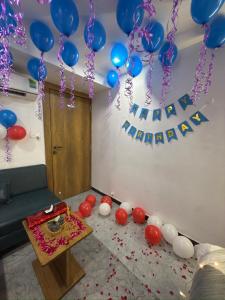 a room with a bunch of balloons and a table at Hotel secure inn kadodara road in Surat