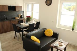 a living room with a couch and a table at BSApartament in Piwniczna-Zdrój