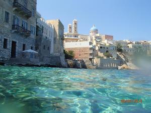 a view of a body of water next to buildings at Kalypso's apt in Hermoupolis rooftop with seaview in Ermoupoli
