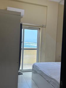 a bedroom with a bed and a view of the ocean at Aluruba Residence in Mogadishu +3 photos