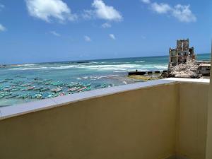 a view of the ocean from the balcony of a hotel at Aluruba Residence in Mogadishu