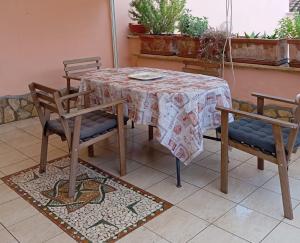 a table with two chairs and a table with a table cloth at Casa Mare Teulada Sardegna in Teulada