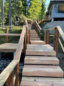 a wooden staircase leading up to a house at Saimaanranta mökki in Kokkoniemi