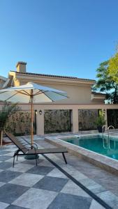 a table with an umbrella next to a swimming pool at Burada in Baku