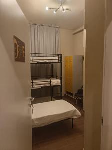 a room with two bunk beds and a door at Monkey Hostel Milano in Milan +49 photos