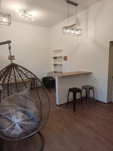 a room with chairs and a table and a counter at Monkey Hostel Milano in Milan