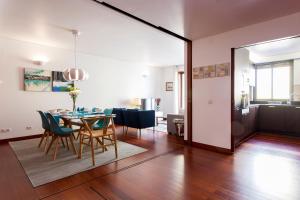 a dining room and living room with a table and chairs at Charming 2-Bedroom Apartment in the City Centre in Lisbon