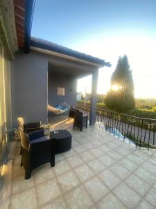 a patio with couches and chairs on a balcony at Pinzalez 