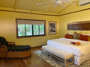 a bedroom with a large bed and a window at Mawamba Lodge in Tortuguero