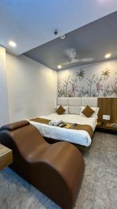 a bedroom with a large bed with a large wall at Hotel secure inn kadodara road in Surat