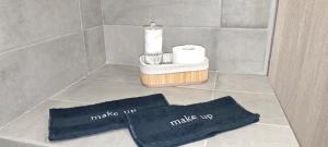 a bathroom with two towels and a basket of toilet paper at Alexandras Maisonette in Skiathos +8 photos