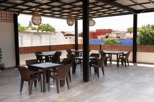 a group of tables and chairs on a patio at Hotel Mayis in Oaxaca City