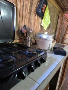 a stove top oven sitting on a kitchen counter at Erina Beach in Antalaha