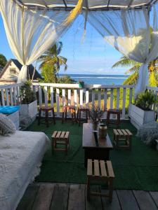 a patio with tables and chairs and a view of the ocean at Erina Beach in Antalaha