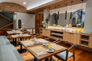 a restaurant with wooden tables and chairs and a kitchen at Hotel Nevada in San Carlos de Bariloche
