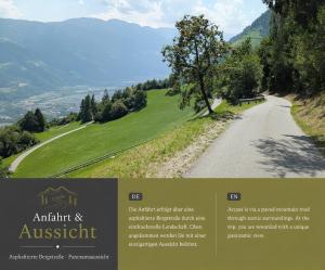 a road with a tree on the side of a hill at Greiterhof Partschins in Parcines