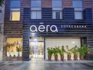 a store front with potted plants in front of it at Aera Rio de Janeiro Copacabana in Rio de Janeiro