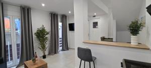 a living room with a chair and a mirror at Alexandras Maisonette in Skiathos