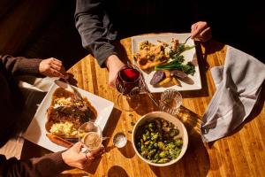 two people sitting at a table with plates of food at Huntley Lodge at Big Sky Resort in Big Sky