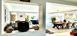 a living room and dining room with a large mirror at Maisonn La Turbie - Privateee pool in La Turbie