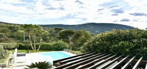 a swimming pool in a garden with a view of a mountain at Maisonn La Turbie - Privateee pool in La Turbie