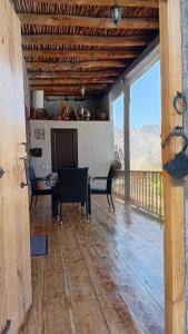 a living room with a table and chairs on a wooden floor at Ani guest house in Meghri