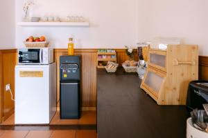 a kitchen with a refrigerator and a counter with fruit at Hospedaria Canto do Rossio in Vidigueira +23 photos