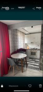 a kitchen with a table and chairs in a room at Vladimir City 60 in Volodymyr-Volynskyi