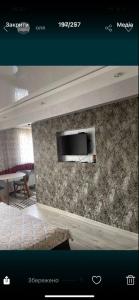 a room with a television on a wall at Vladimir City 60 in Volodymyr-Volynskyi