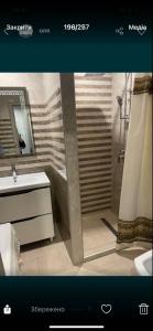 a bathroom with a shower and a sink at Vladimir City 60 in Volodymyr-Volynskyi