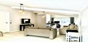 a living room with two couches and a tv at Maisonn La Turbie - Privateee pool in La Turbie +7 photos