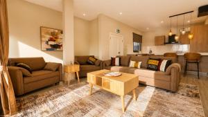a living room with two couches and a table at Teranga Tides in Bijilo