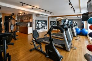a gym with treadmills and exercise equipment in a room at Flat 503 - America in Campos dos Goytacazes