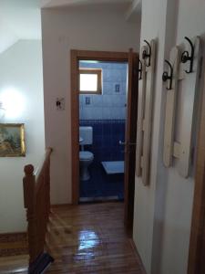 a bathroom with a toilet and a hallway with a door at Mountain View Retreat near Pelister National Park, Huge Garden, Hiking Paradise in Nižepole +34 photos