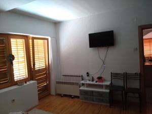 a living room with a flat screen tv on the wall at Mountain View Retreat near Pelister National Park, Huge Garden, Hiking Paradise in Nižepole