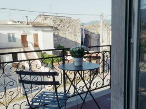 a table and a chair on a balcony at Domus Flumen in Alife