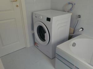 a white washer and dryer in a bathroom at Domus Flumen in Alife