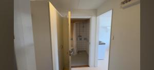 an open door to a bathroom with a toilet in a room at Mangatan 2 in Borlänge