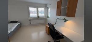 a bedroom with a desk and a bed and a chair at Mangatan 2 in Borlänge