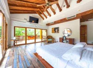 a bedroom with a large bed and a television at Casa Las Palmas in San Andrés +55 photos