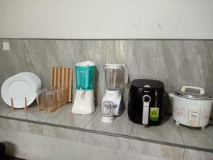 a counter with several blenders sitting on a shelf at Yara Eleven in Ambalangoda