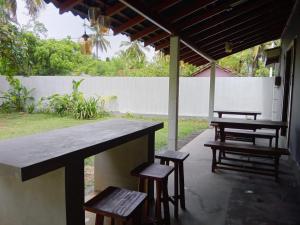 a group of picnic tables and benches under a pavilion at Yara Eleven in Ambalangoda