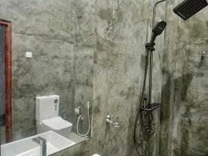 a bathroom with a shower with a toilet and a sink at Yara Eleven in Ambalangoda +46 photos