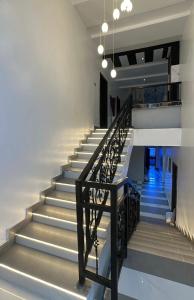 a staircase in a building with a black railing at Eraton Hotel in Warri