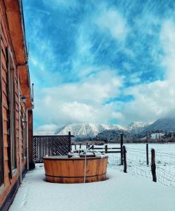 a wooden tub sitting outside of a building in the snow at La Alea Malalcahuello in Malalcahuello