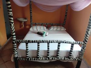 a chair with a pillow and a towel at Bububu creek house in Mombasa