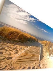 a picture of a boardwalk on a beach at Relax Apartment Backnang in Backnang