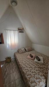 a bedroom with a large bed in a attic at Vikendica Drinski mir in Loznica